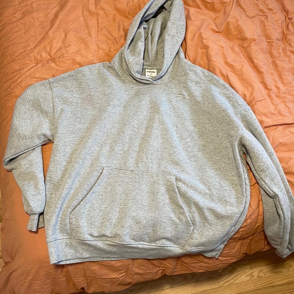 Gray over-sized gymshark hooded sweatshirt.